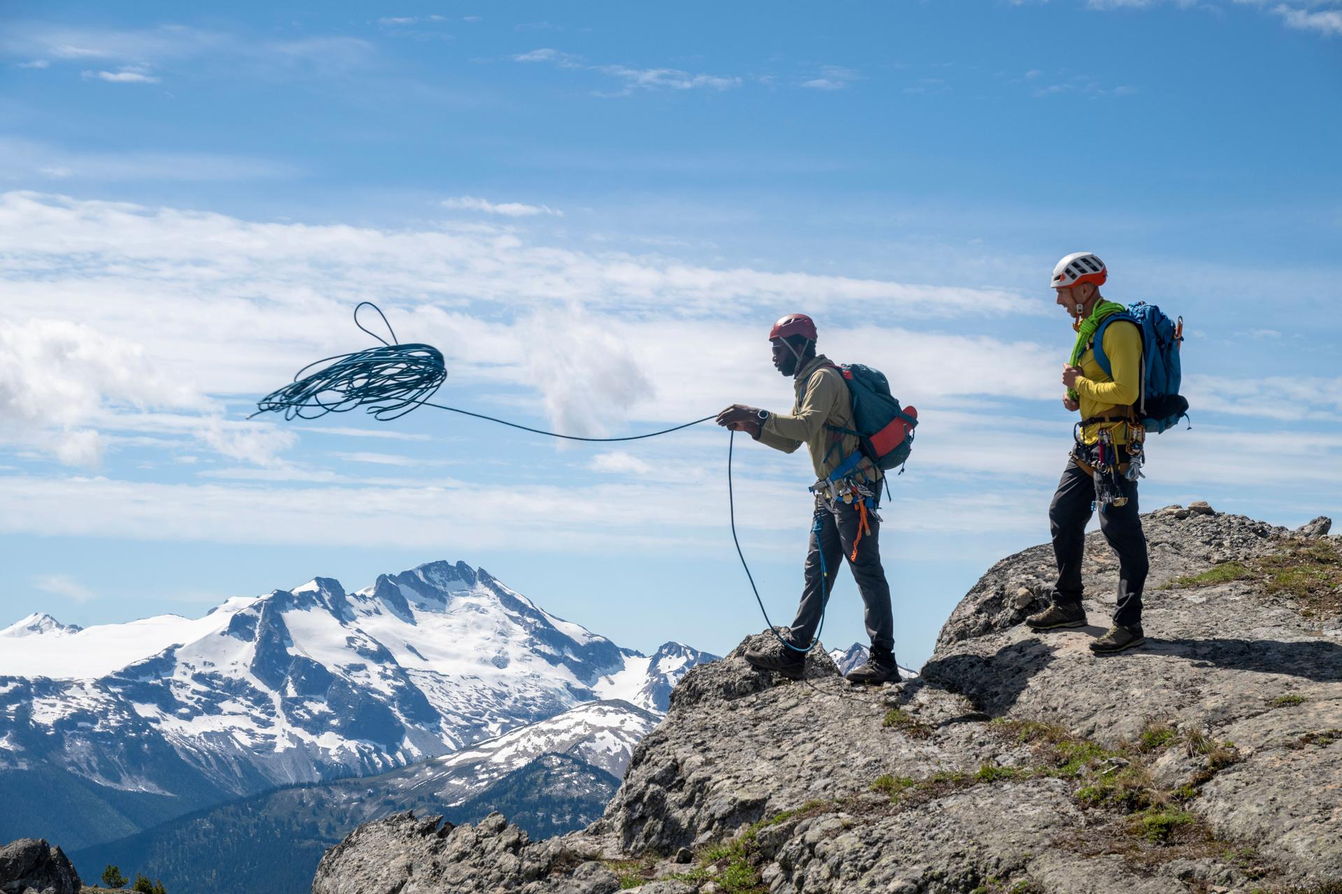 Climbing guide leads guest on mountain ridge