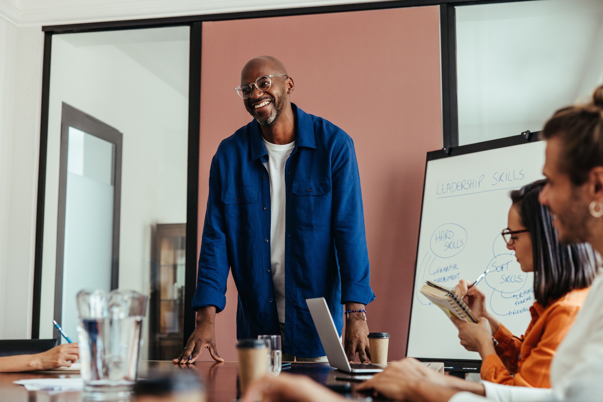 Man leading seminar on leadership skills in a modern boardroom